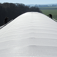 Cobrir o cume ligeiro com folha de tecido num celeiro de lacticínios em Südlohn
